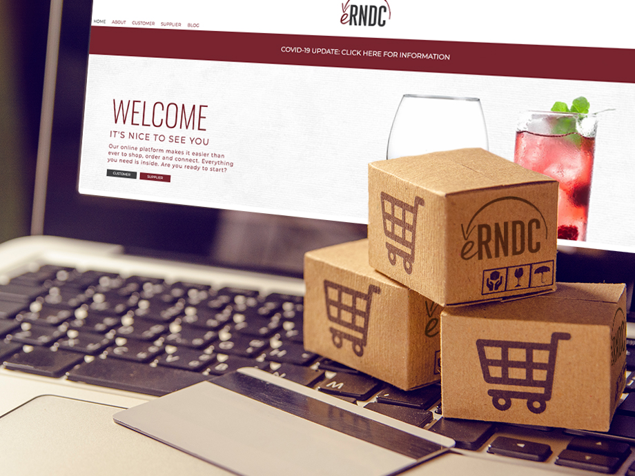 eRNDC a credit card and three small cardboard boxes with shopping cart stamps on laptop keyboard